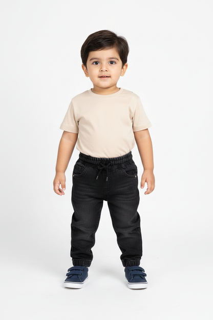 Pakistani baby boy standing - dark denim joggers