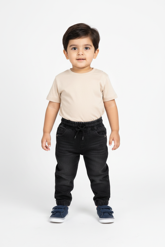 Pakistani baby boy standing - dark denim joggers